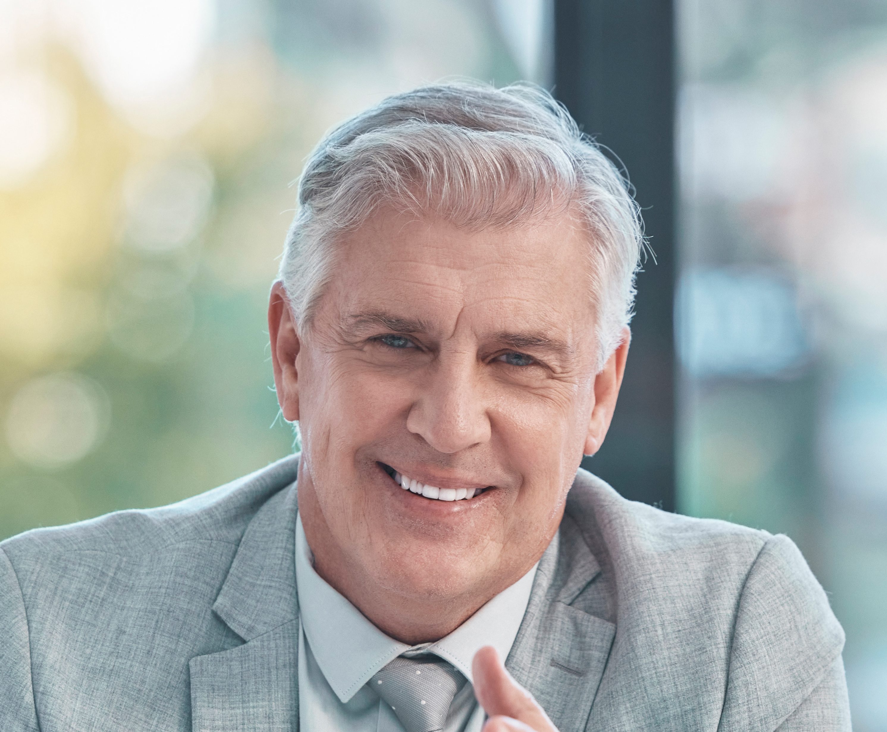 Senior business man, portrait and smile in office at corporate company for testimonial and motivati